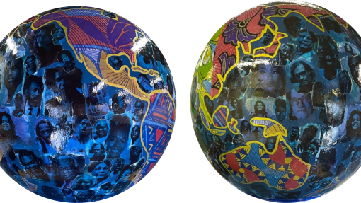 Two globe art sculptures with images of Black Britons on them. 