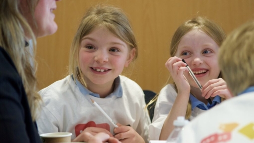 Two children smiling at a conference 