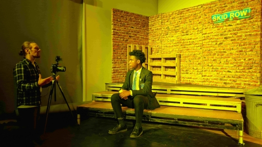 student sat on stage