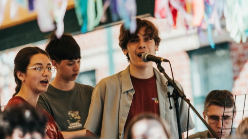 A boy singing in front of a microphone