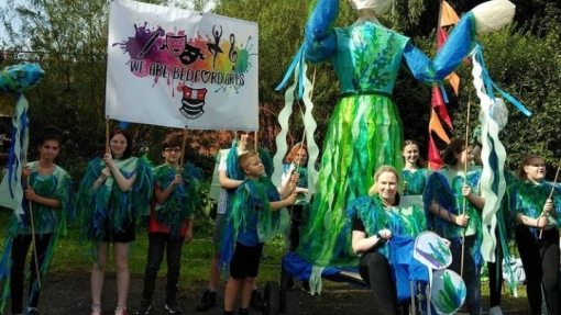 Students parading with a giant puppet