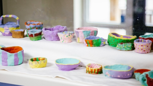 An image of different handmade clay pots, all in different colours. 