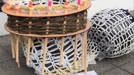 A large 3D sculpture made out of wooden sticks. 