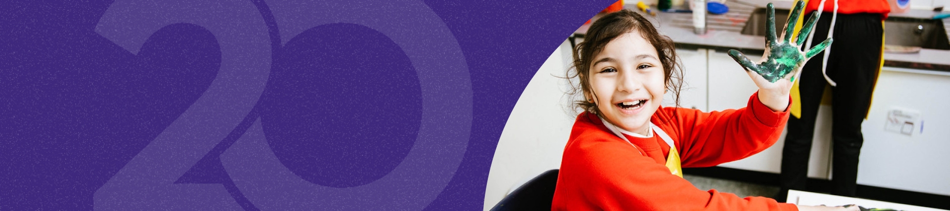 Girl with painted hand waving at camera