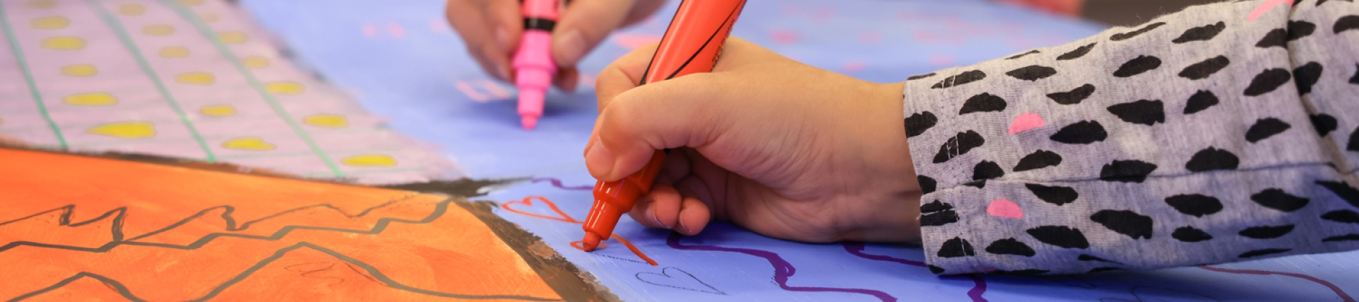 Newcroft - a young people's hands as they draw 