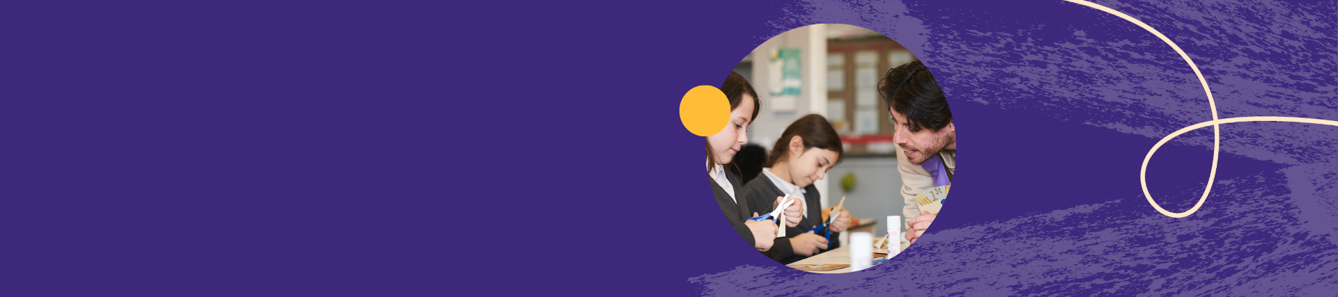 Teacher helping three students with a craft activity in a classroom.