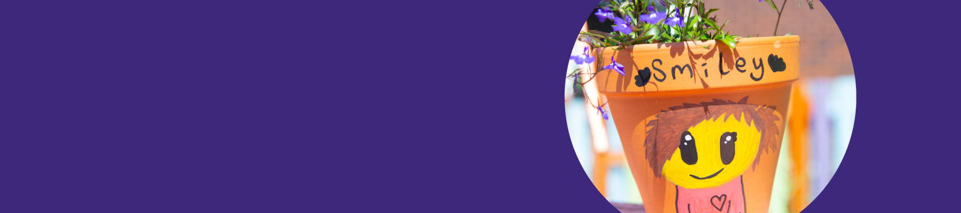 A purple banner with an image of a colourful plant pot that has a happy face painted onto it.