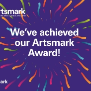 A purple backdrop with exploding lines around the words 'We've achieved our Artsmark Award'