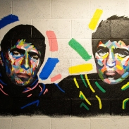 A portrait mural on a wall of the Gallagher brothers from Oasis.