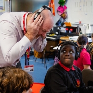  Teacher listening to children play musical instruments