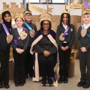 Teacher and students wearing crowns