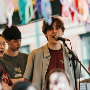 A boy singing in front of a microphone